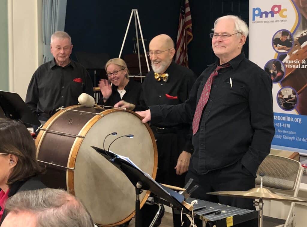Percussionists from PMACs New Horizons Band smiling and waving "hello!"